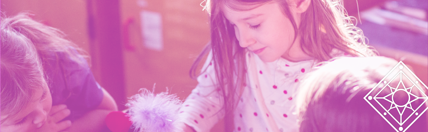 TBDSSAB Child Care and Early Years Programs header image: a young girl sits at a table with other children, focused on an activity