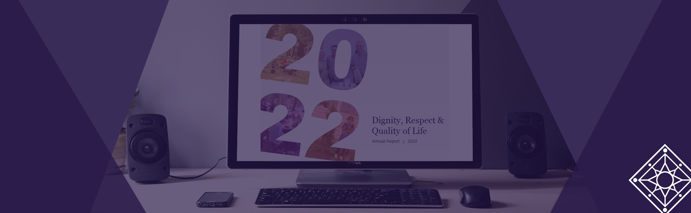 Computer monitor sits on a desk, with the 2022 Annual Report open on the screen. Overlay text reads: 2022 Annual Report