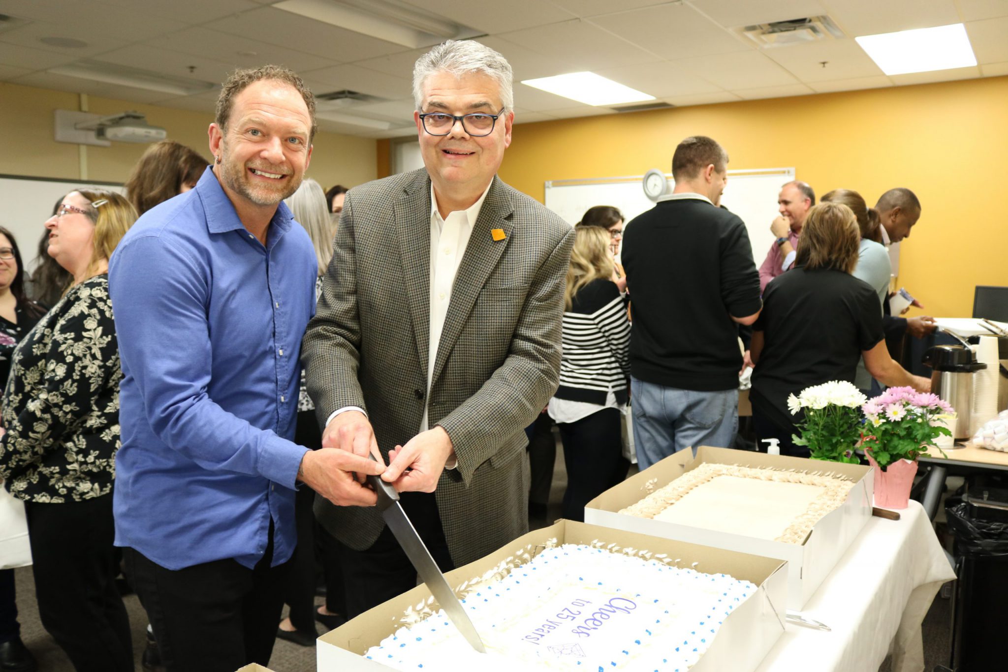 Chair Brian Hamilton and CAO Bill Bradica cutting cake at 25th anniversary celebration